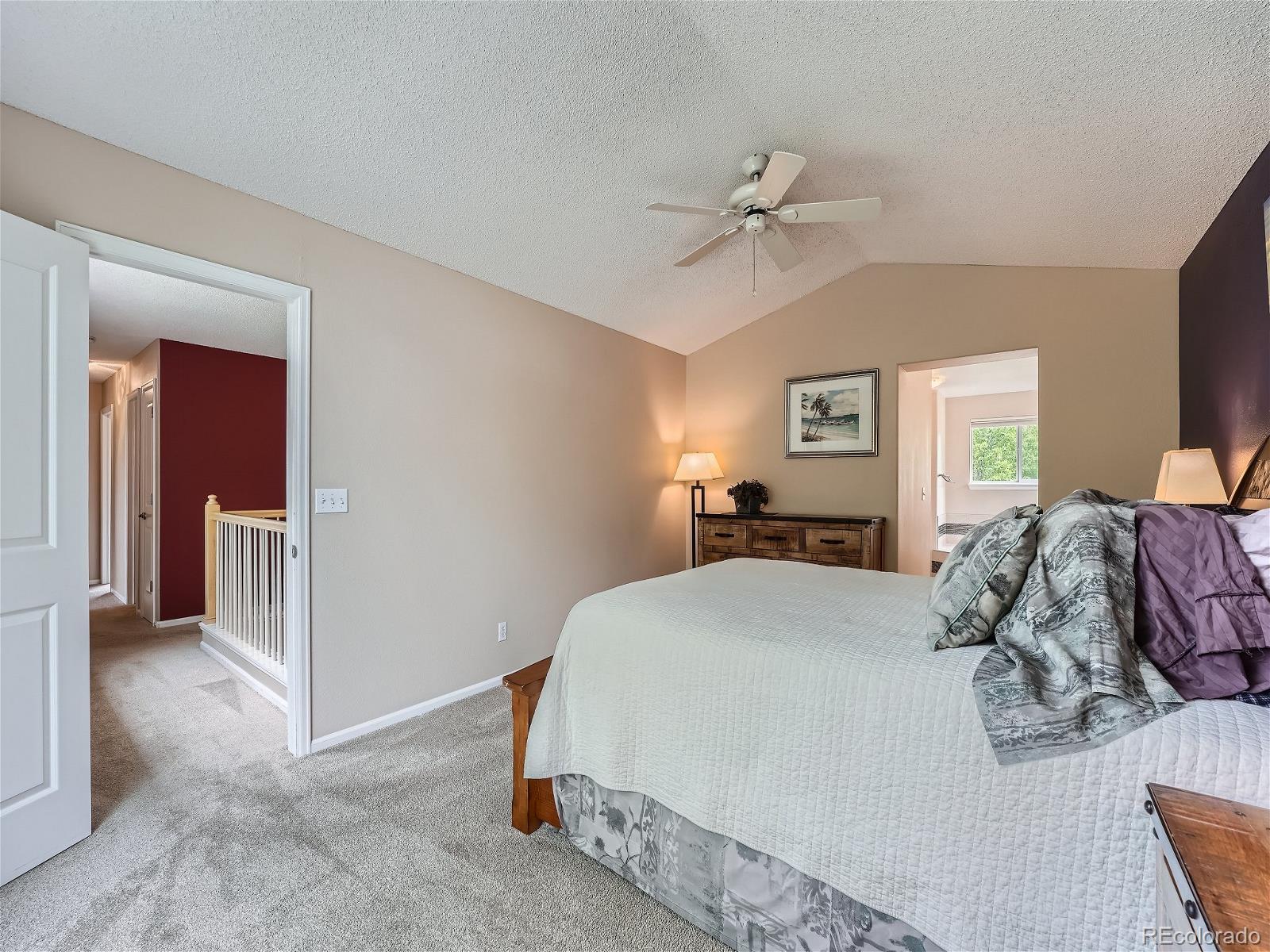 9722 Kipling Street Westminster, CO 80021 - Photo 19 of 37 a spacious bedroom with a bed and a chandelier