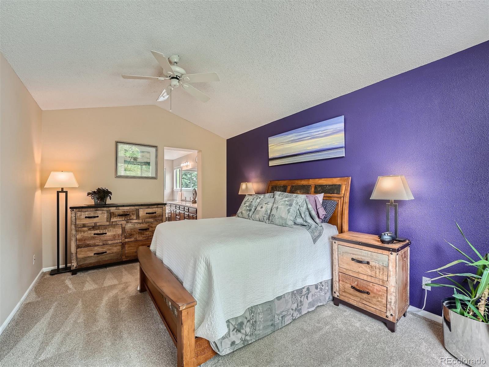 9722 Kipling Street Westminster, CO 80021 - Photo 20 of 37 a bedroom with a bed and a lamp on dresser