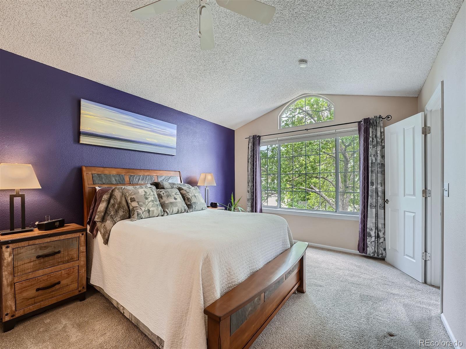 9722 Kipling Street Westminster, CO 80021 - Photo 21 of 37 a bed sitting in a bedroom next to a window