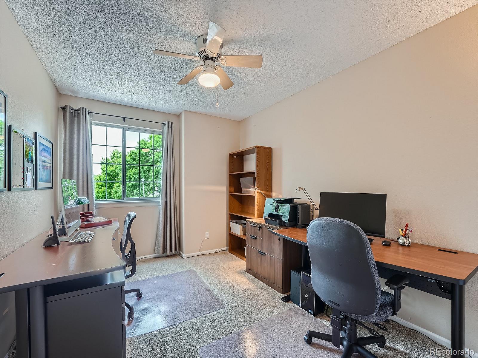9722 Kipling Street Westminster, CO 80021 - Photo 26 of 37 a view of a workspace with furniture and a window