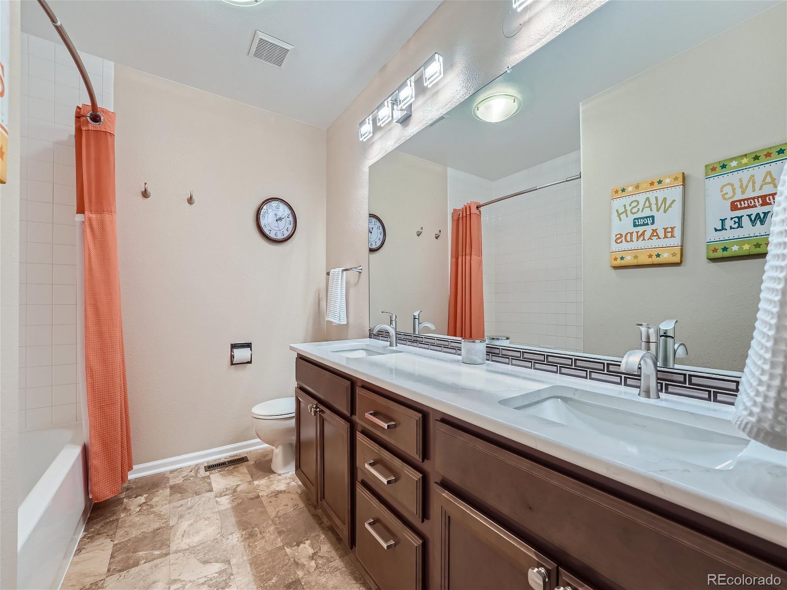 9722 Kipling Street Westminster, CO 80021 - Photo 28 of 37 a bathroom with a sink a mirror and a toilet