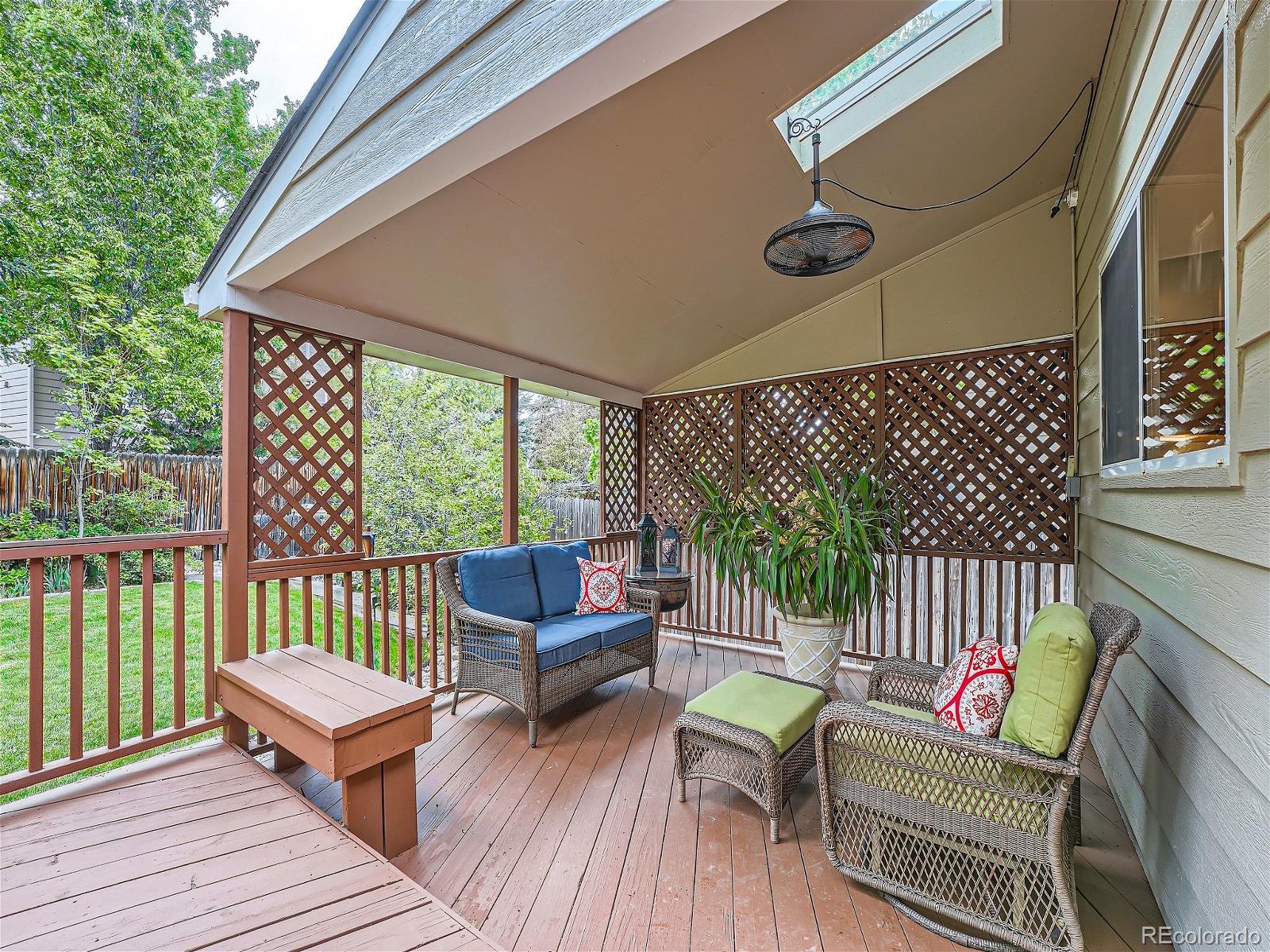 9722 Kipling Street Westminster, CO 80021 - Photo 30 of 37 a balcony with wooden floor table and chairs