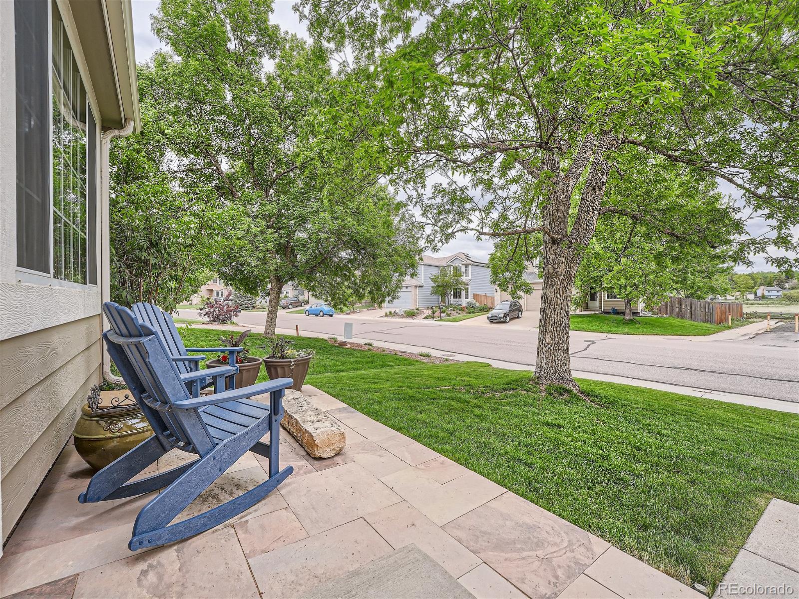 9722 Kipling Street Westminster, CO 80021 - Photo 3 of 37 a view of a sitting area with chairs and a tree