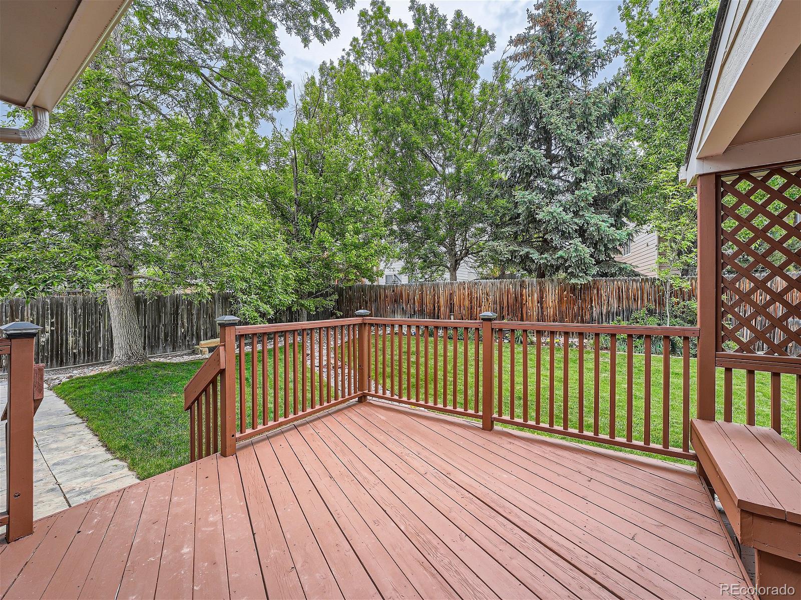 9722 Kipling Street Westminster, CO 80021 - Photo 31 of 37 a view of deck with wooden floor and fence