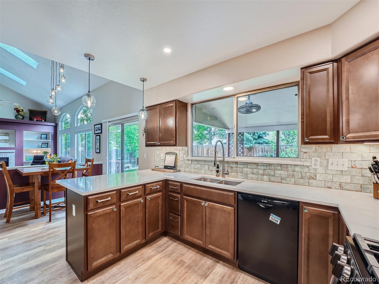 9722 Kipling Street Westminster, CO 80021 - Photo 10 of 37 a kitchen with lots of counter top space sink and center island
