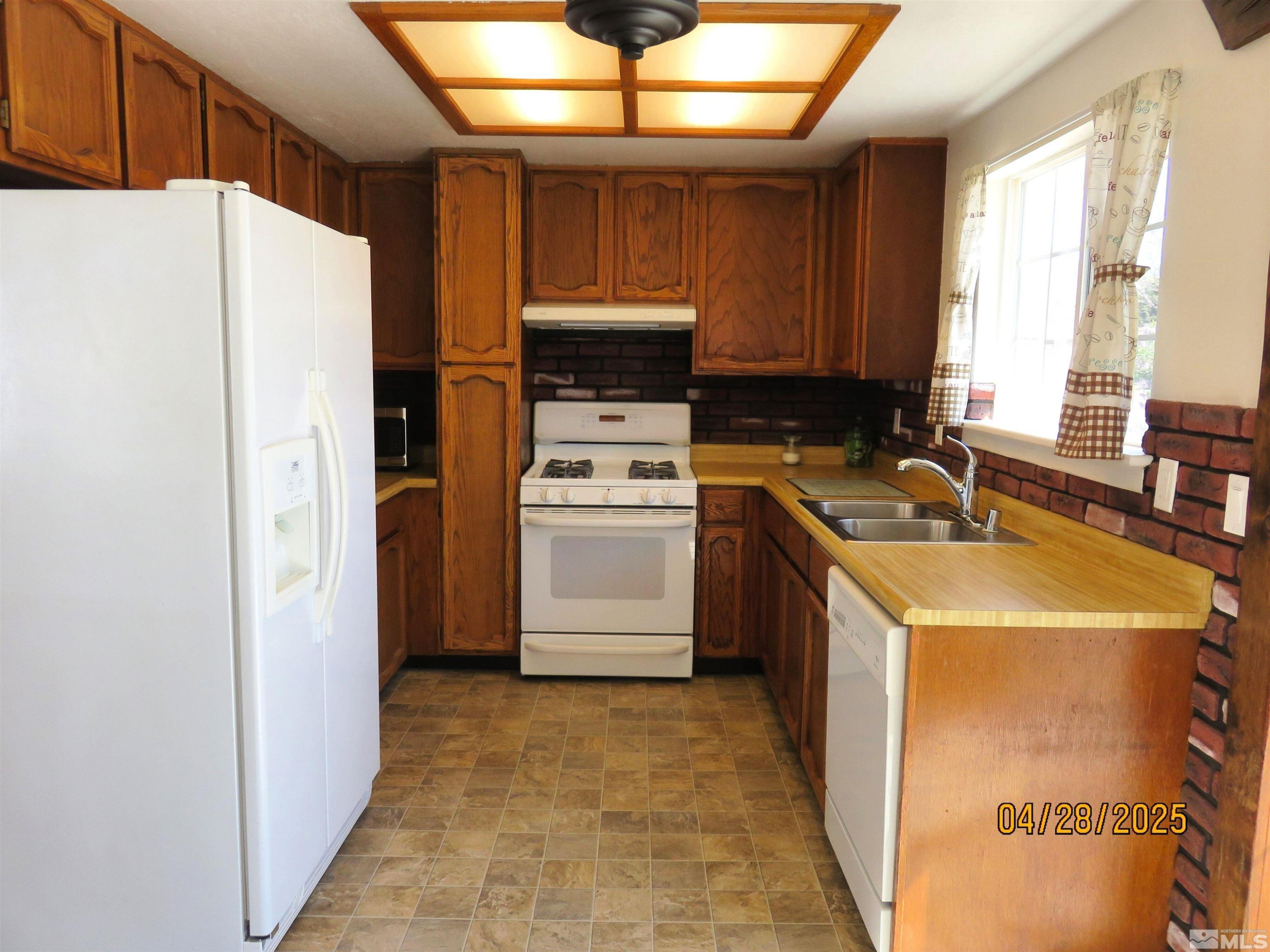 3973 Knoblock Road Carson City, NV 89706 - Photo 12 of 39 a kitchen with a refrigerator sink and a stove