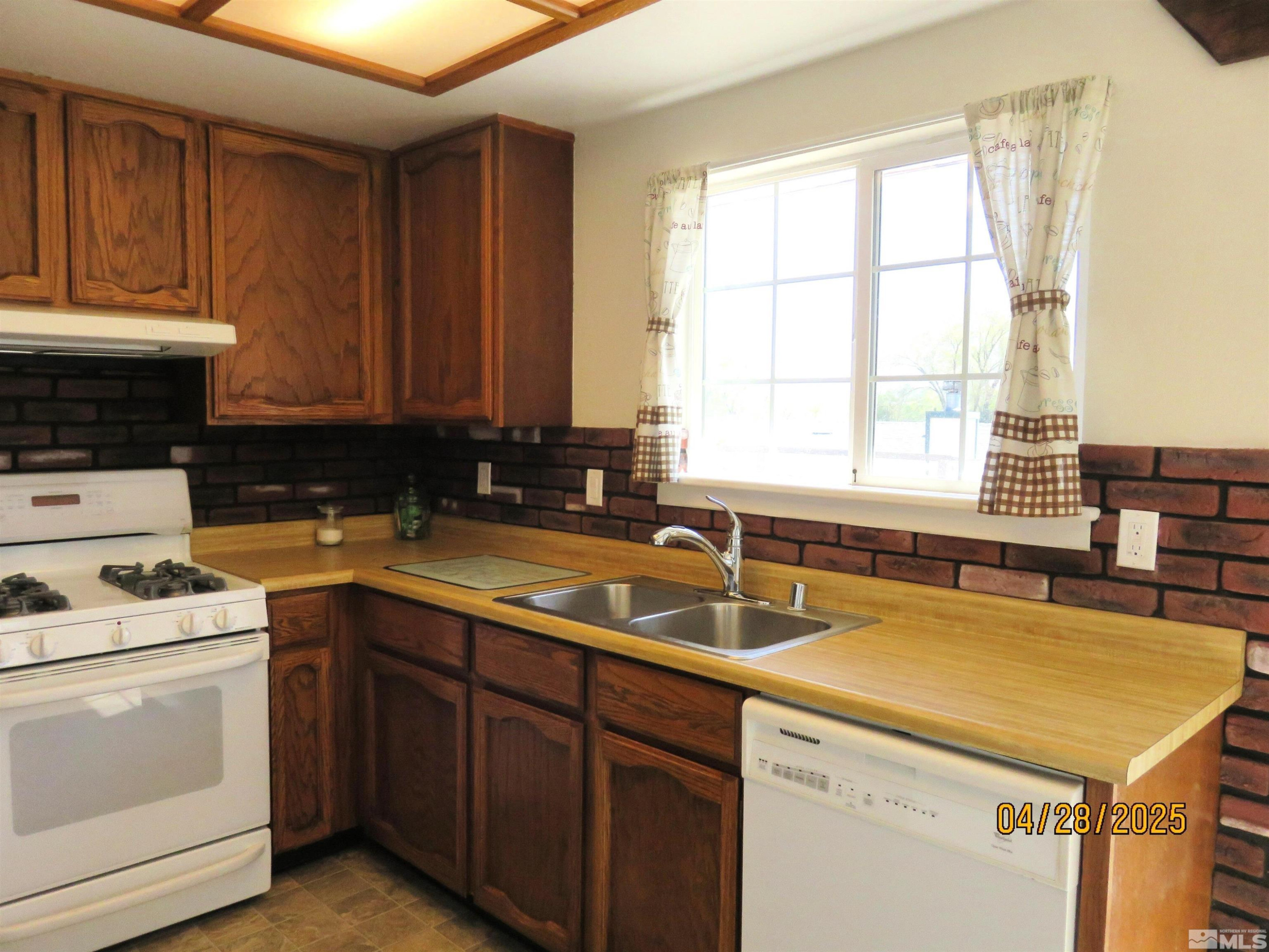3973 Knoblock Road Carson City, NV 89706 - Photo 13 of 39 a kitchen with a sink stove and cabinets