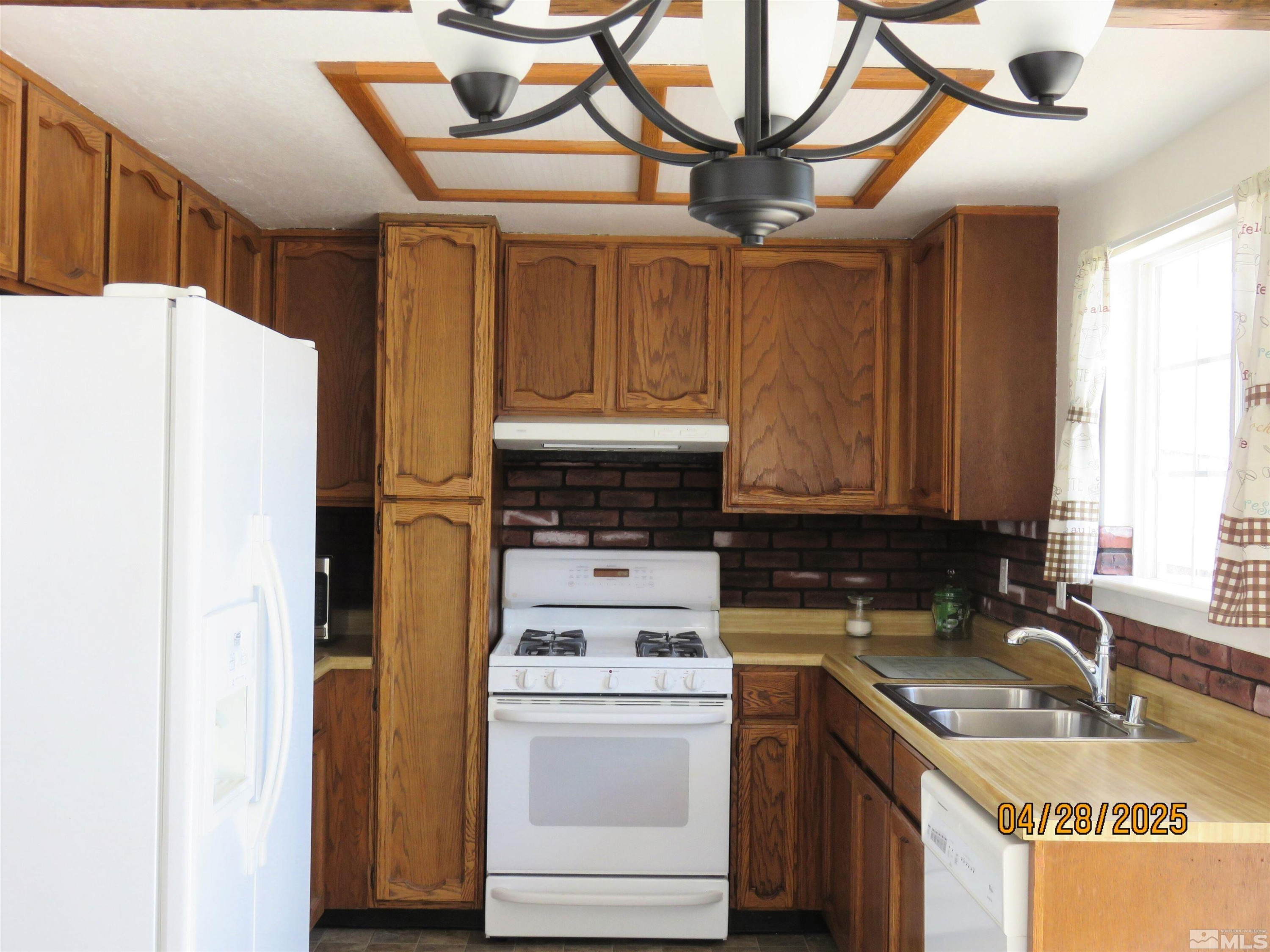 3973 Knoblock Road Carson City, NV 89706 - Photo 14 of 39 a kitchen with a stove a refrigerator and a sink