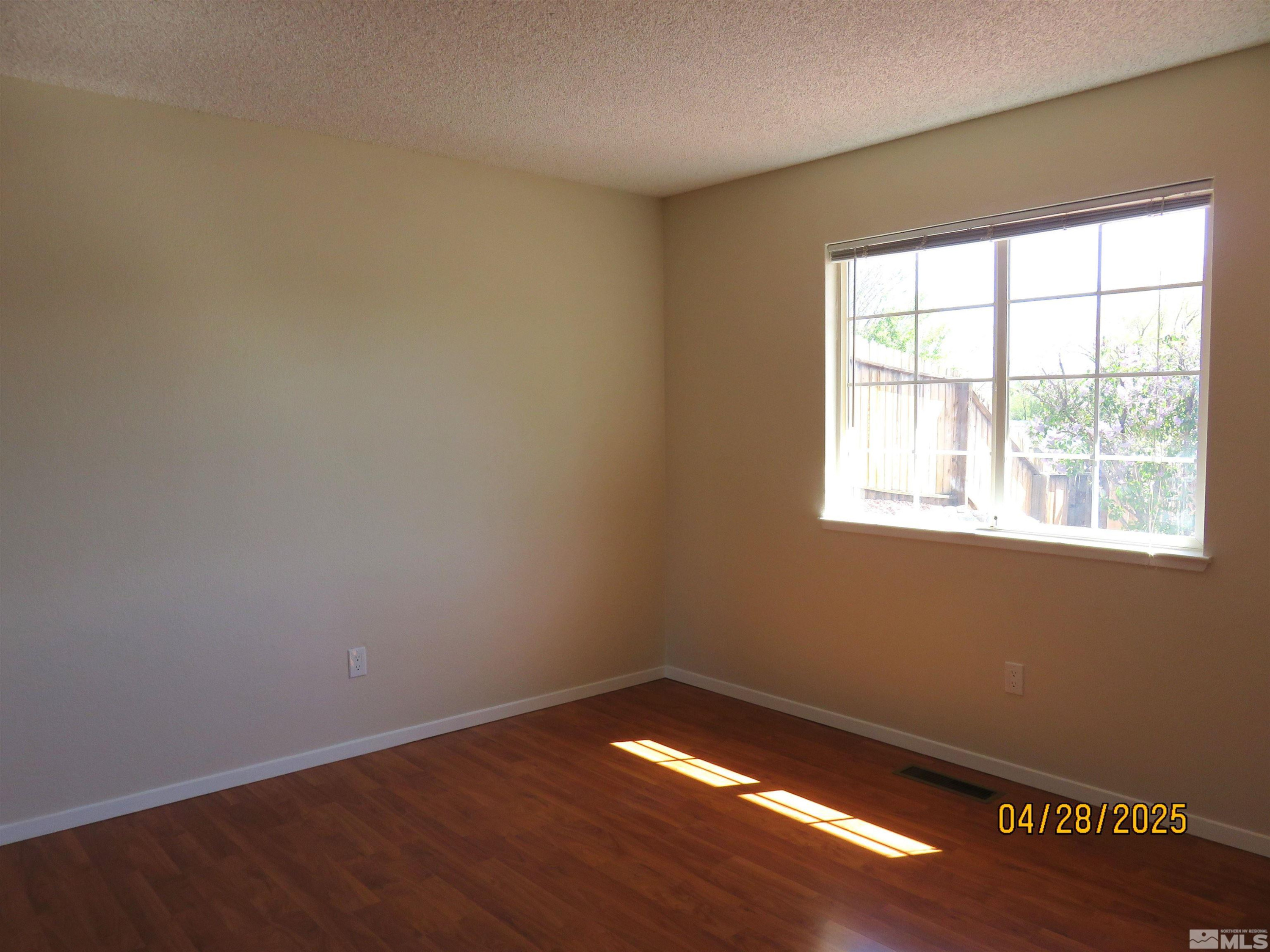 3973 Knoblock Road Carson City, NV 89706 - Photo 24 of 39 a view of an empty room with wooden floor and a window