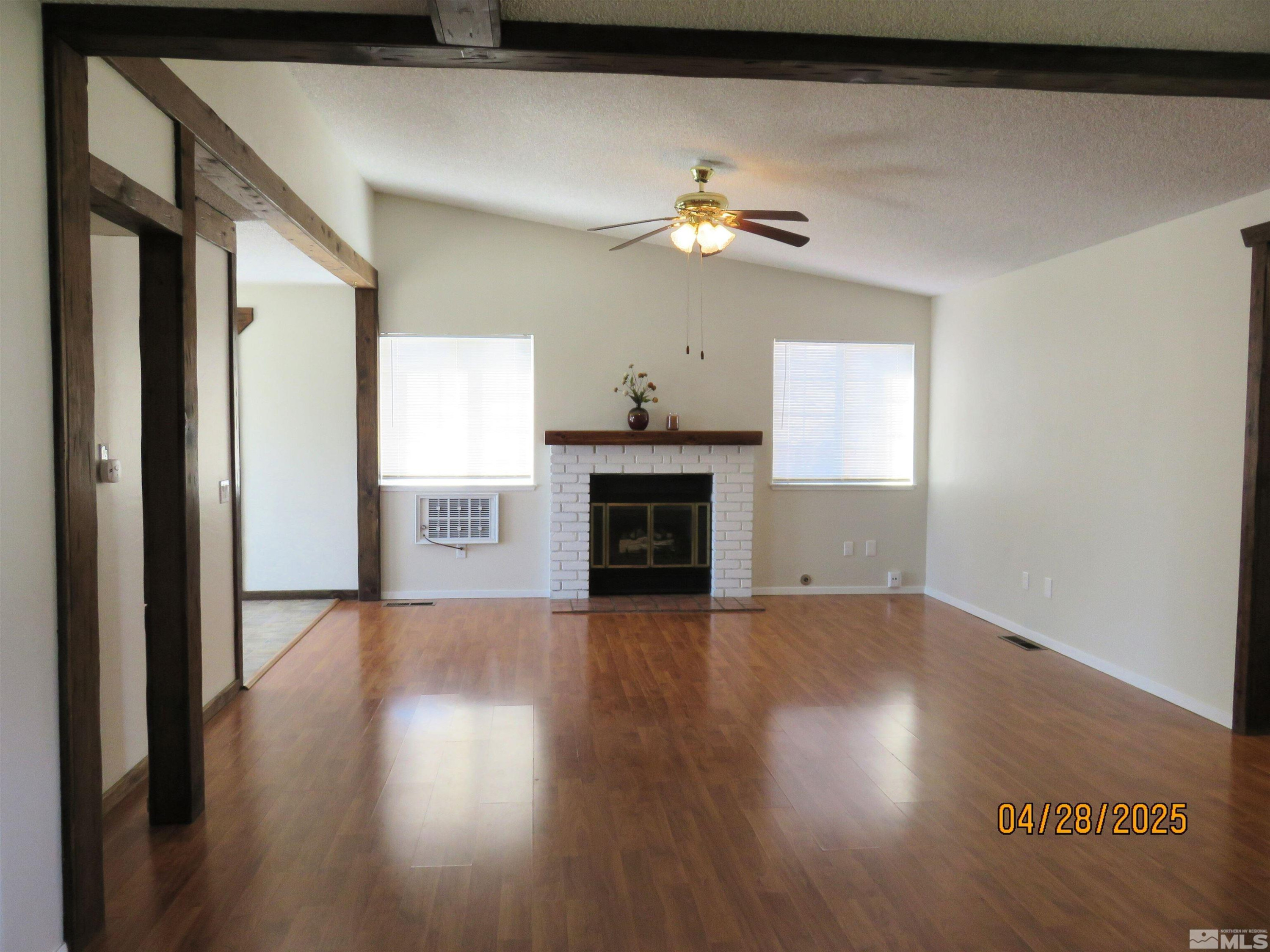 3973 Knoblock Road Carson City, NV 89706 - Photo 4 of 39 a view of a livingroom with wooden floor a ceiling fan and a kitchen