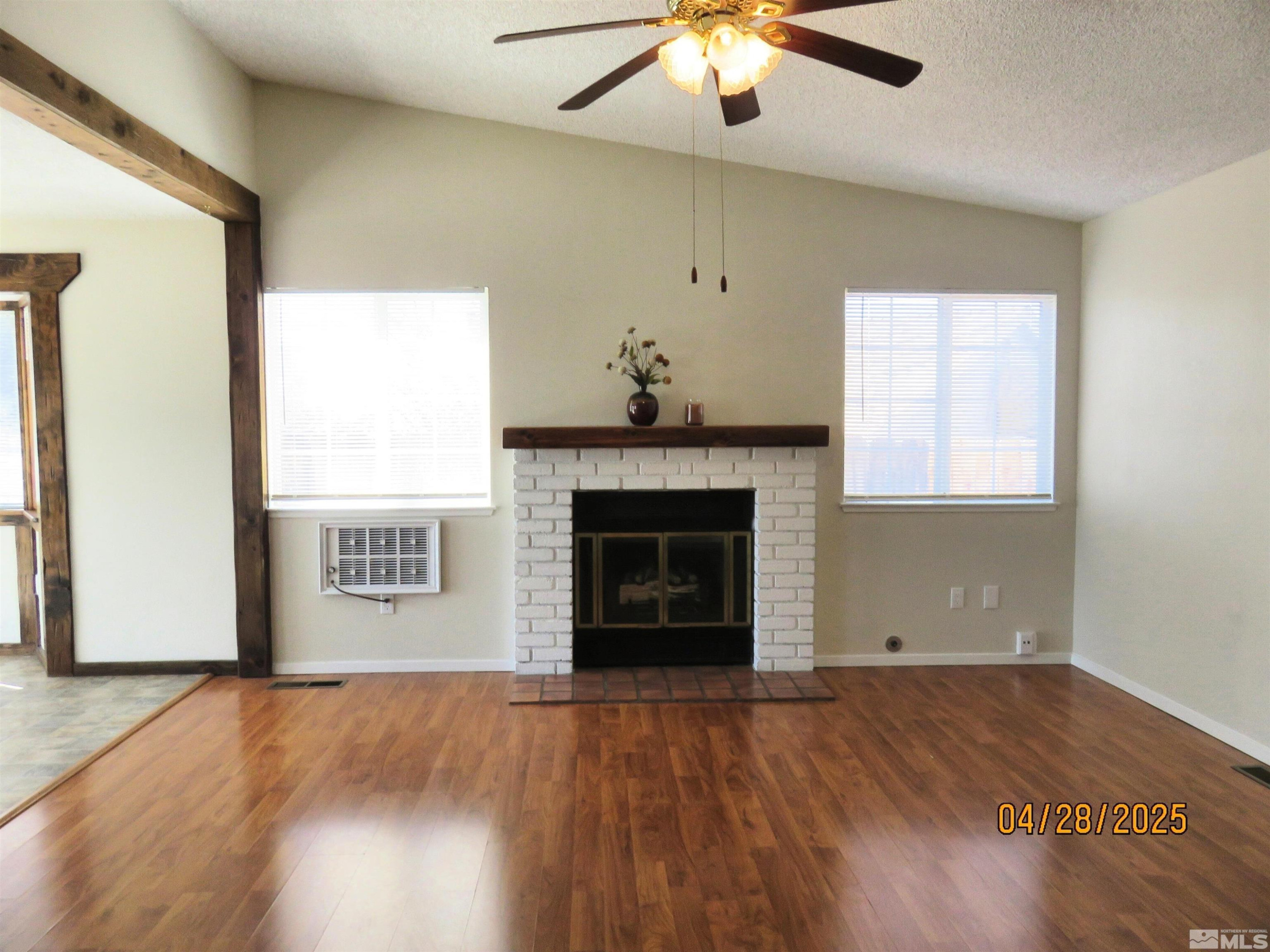 3973 Knoblock Road Carson City, NV 89706 - Photo 6 of 39 an empty room with a fireplace and windows