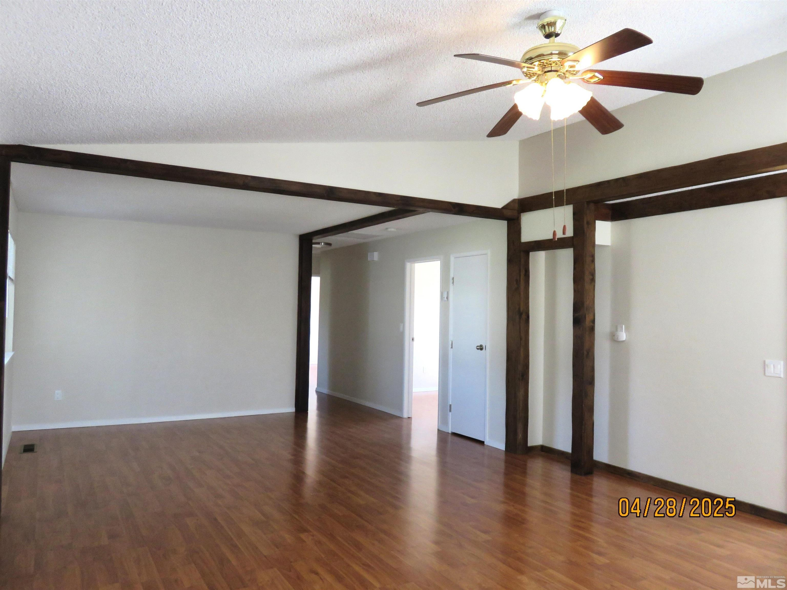 3973 Knoblock Road Carson City, NV 89706 - Photo 7 of 39 a view of an empty room with wooden floor