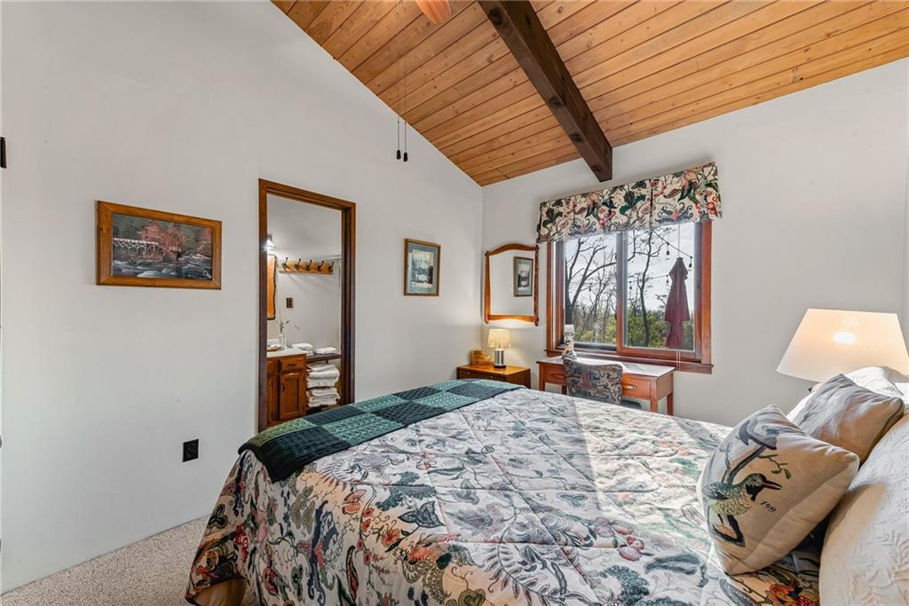 256 Alpine Heights Road Champion, PA 15622 - Photo 21 of 50 a bedroom with a bed and a chandelier