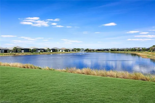 a view of a lake with houses in the back