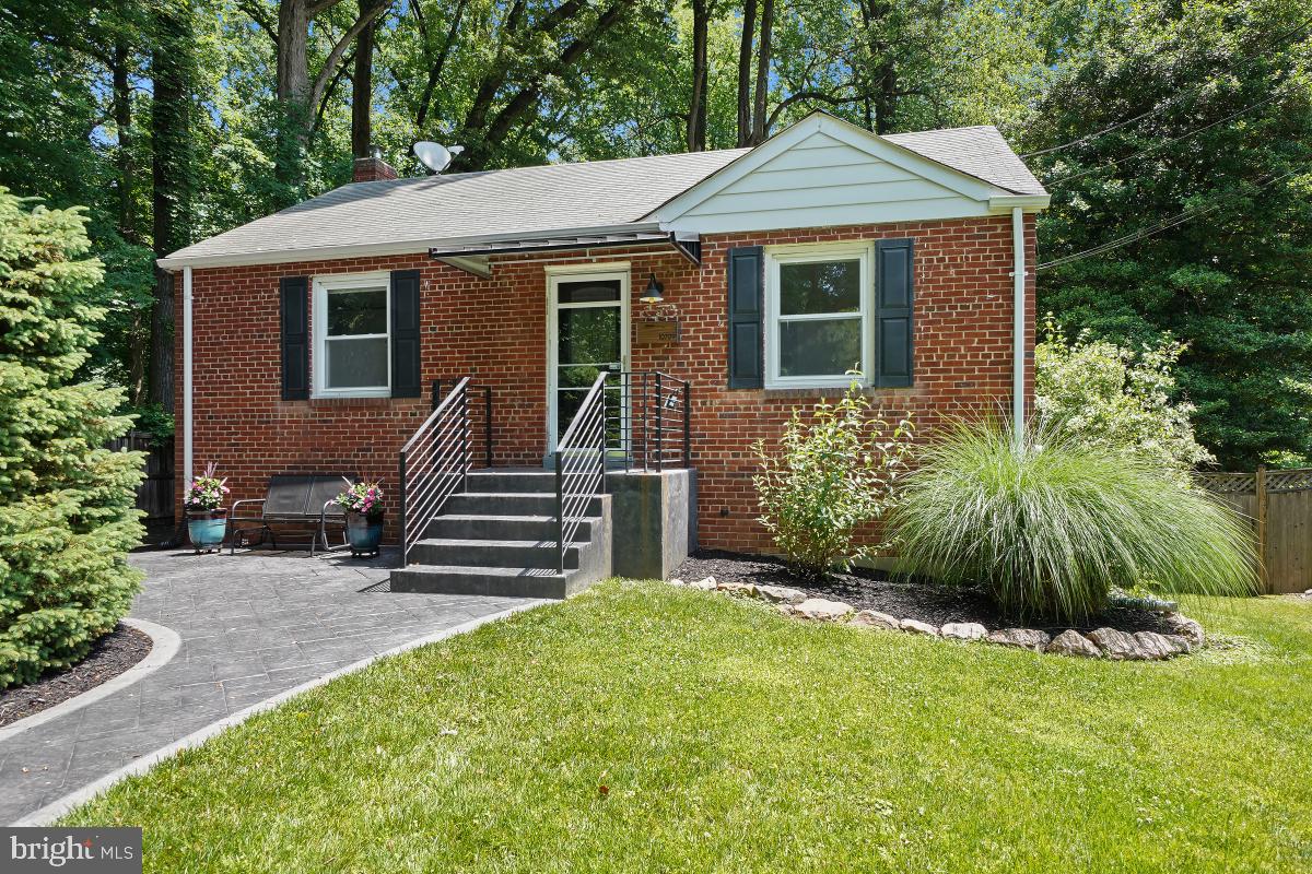 10709 Malone Street Silver Spring, MD 20902 - Photo 1 of 46 a front view of a house with a garden
