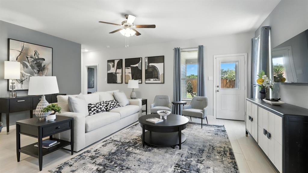304 Perk Street Keene, TX 76059 - Photo 11 of 34 a living room with furniture a chandelier and a window