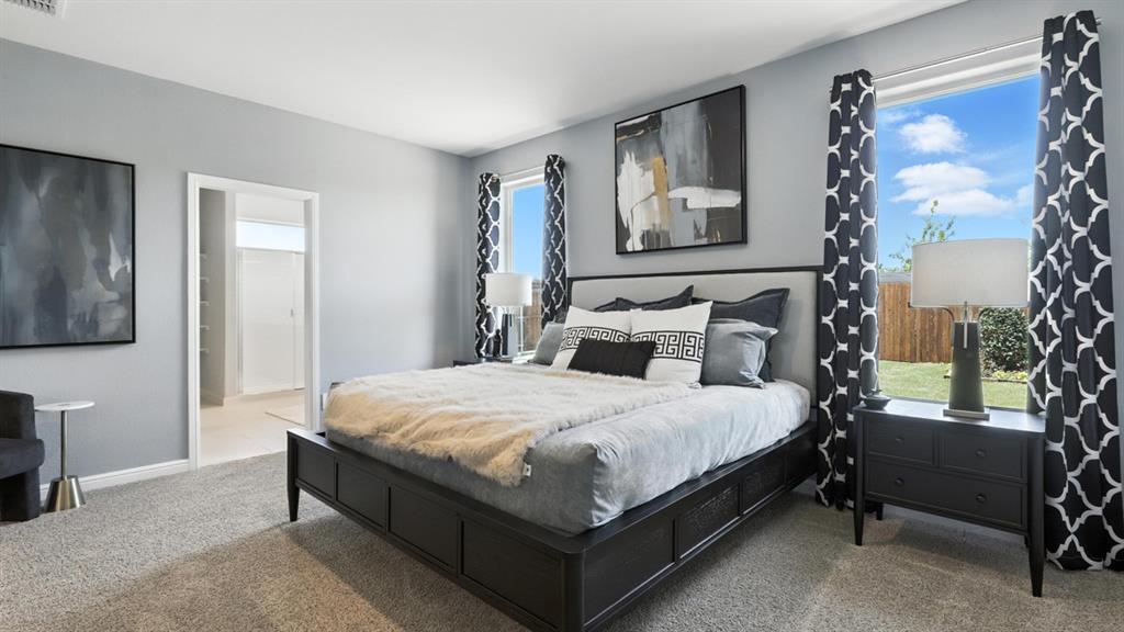 304 Perk Street Keene, TX 76059 - Photo 13 of 34 a large bed sitting in a bedroom next to a window and a lamp