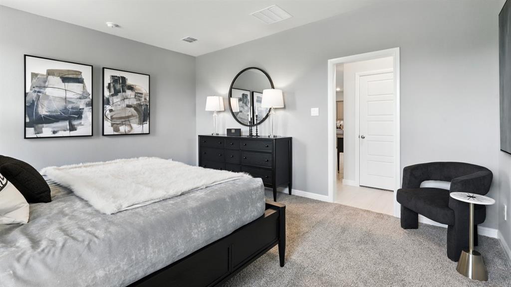 304 Perk Street Keene, TX 76059 - Photo 15 of 34 a bedroom with a bed and a painting on the wall