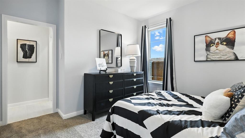 304 Perk Street Keene, TX 76059 - Photo 27 of 34 a bedroom with a bed and a table in it