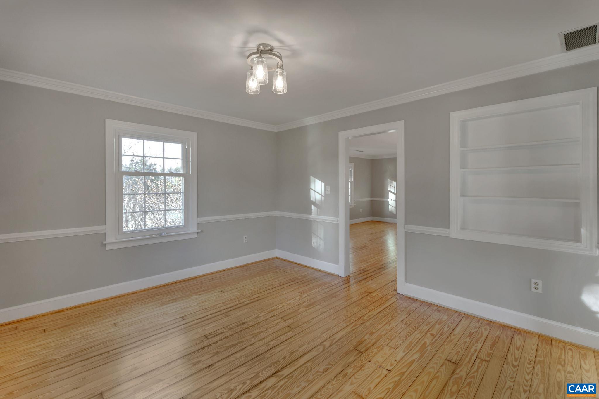 3432 Keswick Road Keswick, VA 22947 - Photo 21 of 60 a view of an empty room with a window and wooden floor