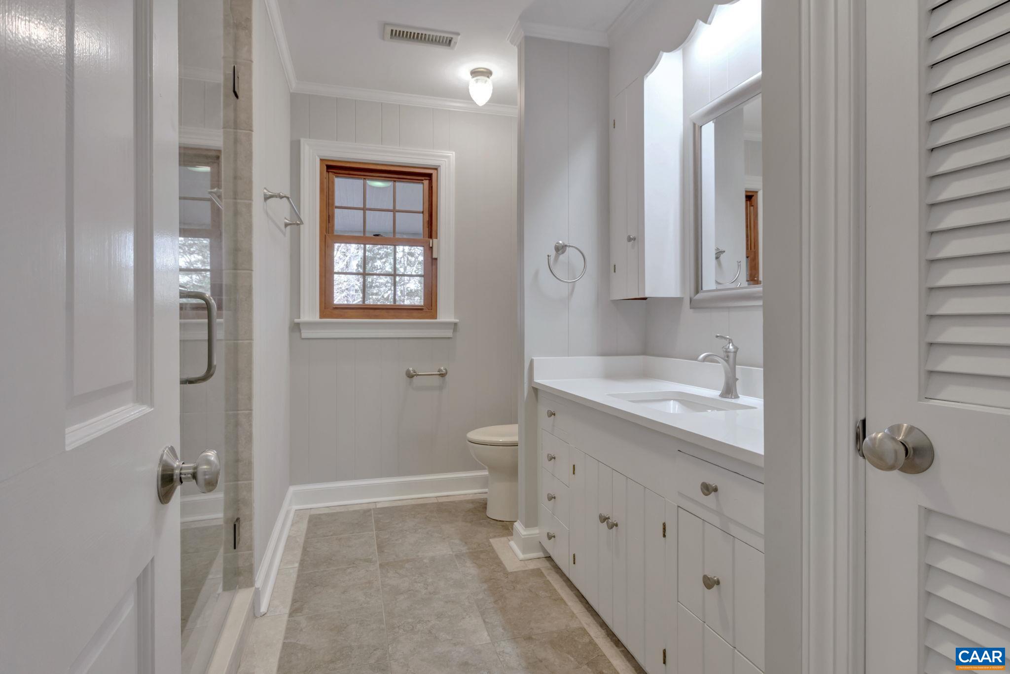 3432 Keswick Road Keswick, VA 22947 - Photo 25 of 60 a bathroom with a granite countertop sink toilet and shower