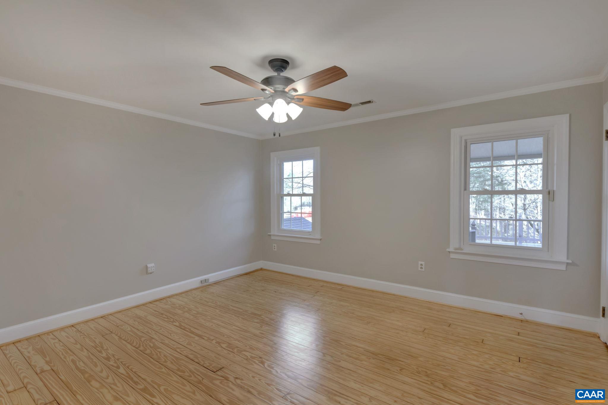3432 Keswick Road Keswick, VA 22947 - Photo 28 of 60 an empty room with wooden floor fan and windows