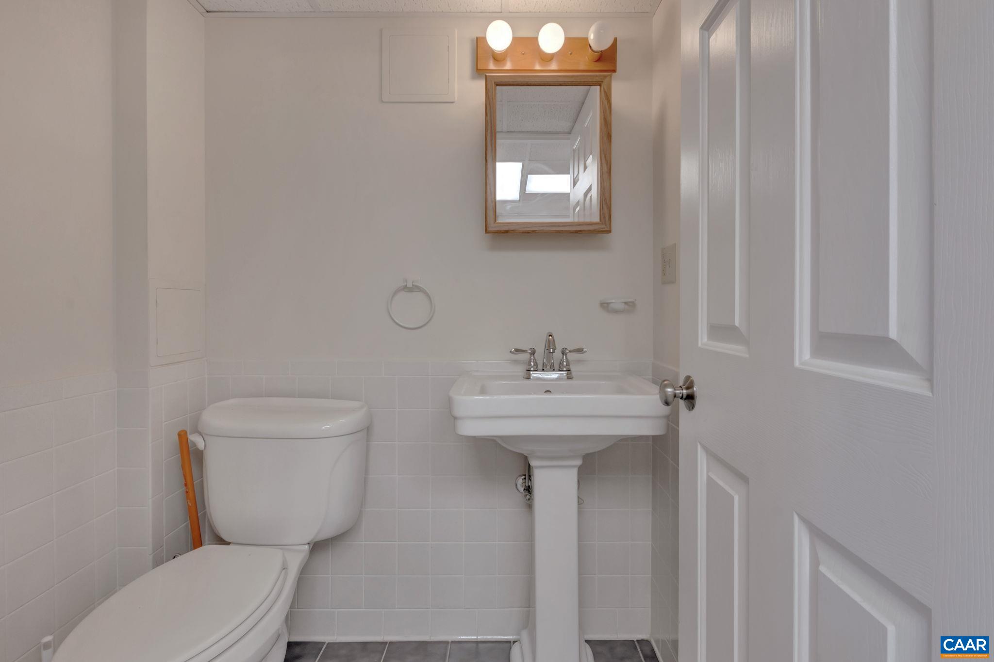 3432 Keswick Road Keswick, VA 22947 - Photo 45 of 60 a bathroom with a toilet sink and mirror
