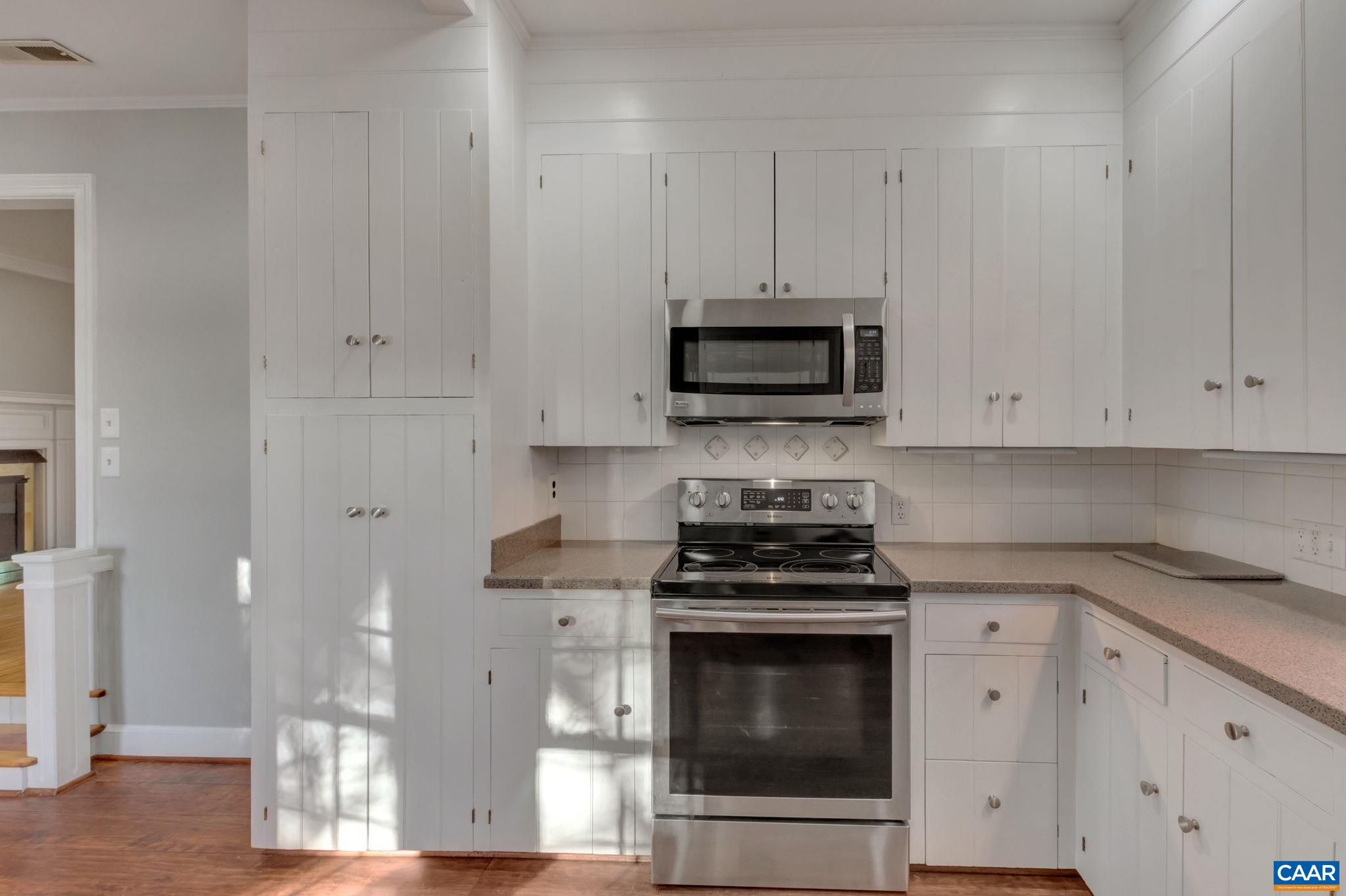 3432 Keswick Road Keswick, VA 22947 - Photo 8 of 60 a kitchen with stainless steel appliances a stove a microwave and cabinets