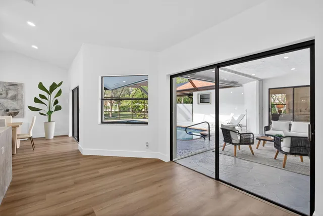 a spacious bedroom with a bed and a flat screen tv