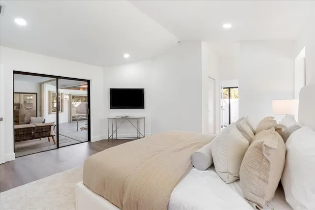 a bedroom with a bed and a flat screen tv