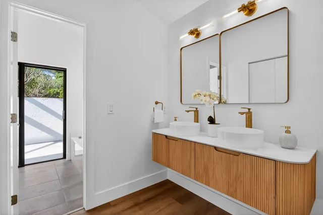 a spacious bathroom with a double vanity sink and mirror