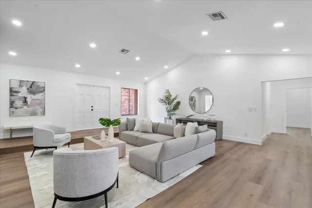 a living room with furniture a rug and a chandelier