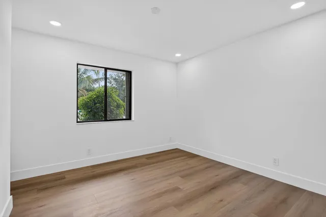 a bathroom with a double vanity sink mirror and bathtub
