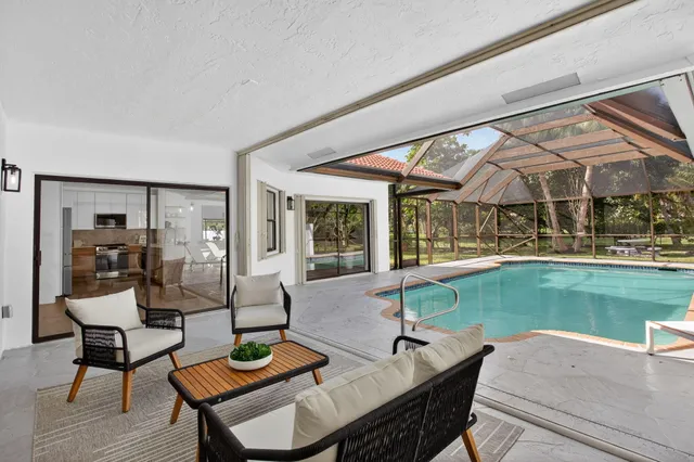 a view of a house with backyard sitting area and garden