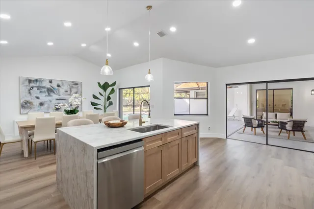 a kitchen with refrigerator cabinets dining table and chairs
