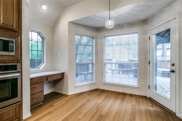 a view of room with furniture and wooden floor