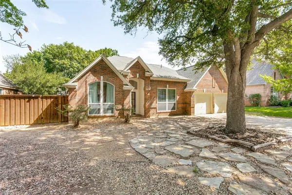 a view of a house with a tree in the background