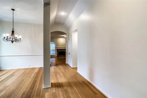 a view of a room with wooden floor