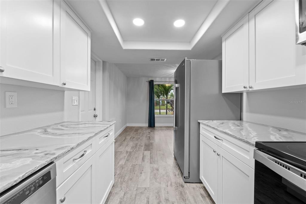 4238 Glissade Drive New Port Richey, FL 34652 - Photo 13 of 62 a kitchen with a sink stove and cabinets
