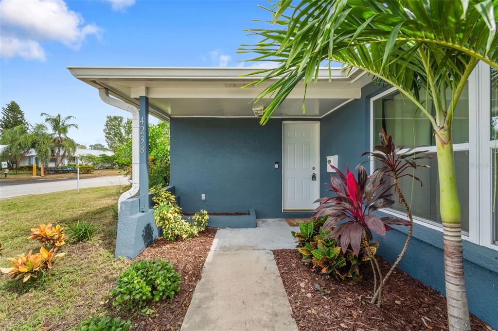 4238 Glissade Drive New Port Richey, FL 34652 - Photo 2 of 62 a front view of a house with garden