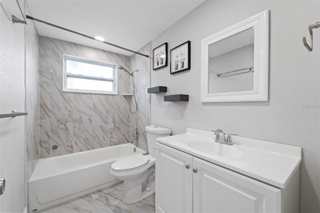 4238 Glissade Drive New Port Richey, FL 34652 - Photo 21 of 62 a bathroom with a sink a toilet and a bathtub