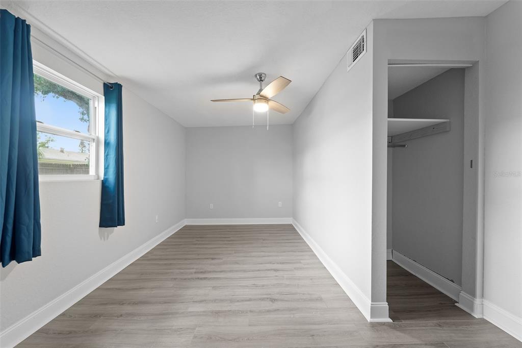 4238 Glissade Drive New Port Richey, FL 34652 - Photo 28 of 62 wooden floor in an empty room with a window