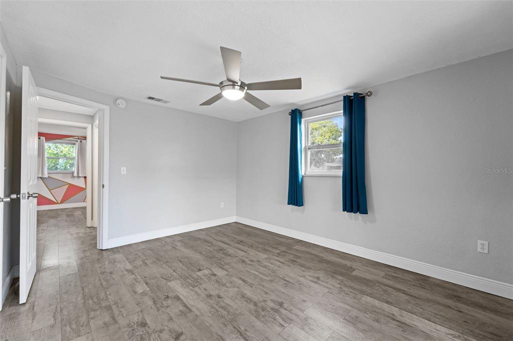 4238 Glissade Drive New Port Richey, FL 34652 - Photo 29 of 62 a view of an empty room with window and wooden floor
