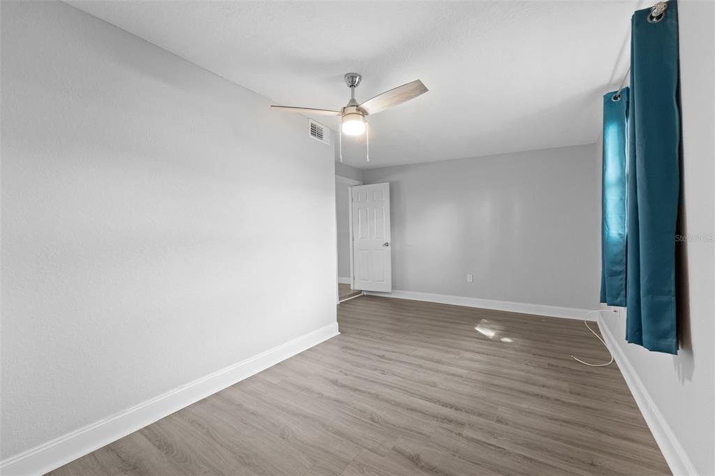 4238 Glissade Drive New Port Richey, FL 34652 - Photo 31 of 62 wooden floor in an empty room
