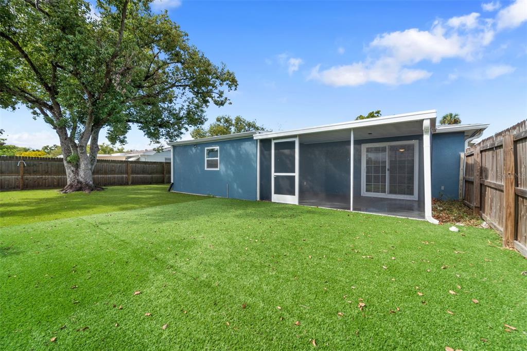 4238 Glissade Drive New Port Richey, FL 34652 - Photo 40 of 62 a view of an house with backyard space and garden