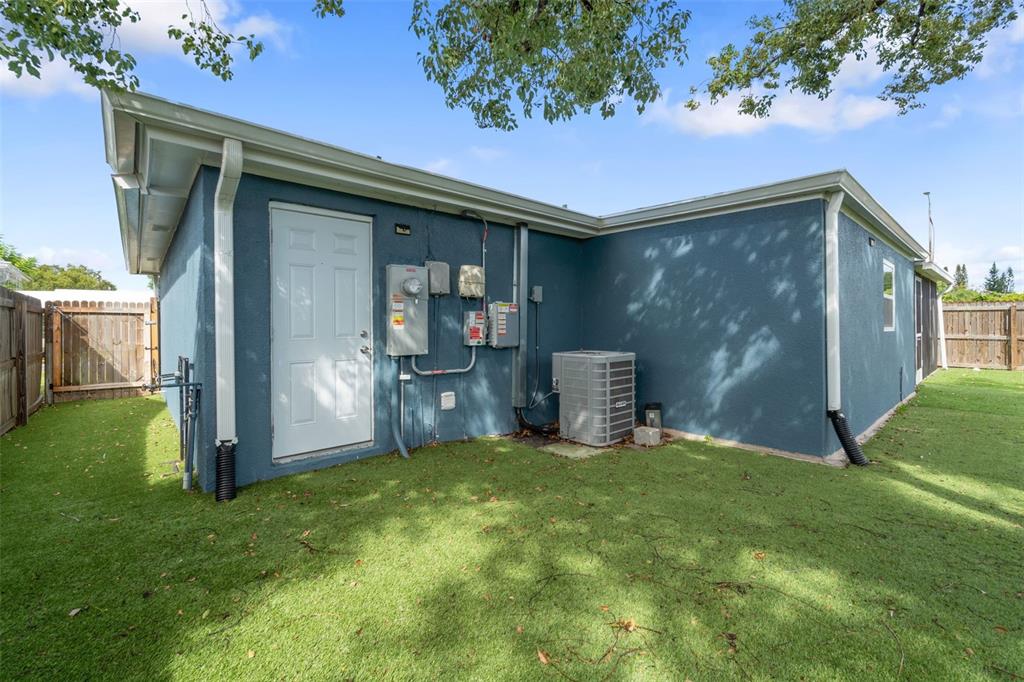 4238 Glissade Drive New Port Richey, FL 34652 - Photo 43 of 62 a backyard of a house with table and chairs