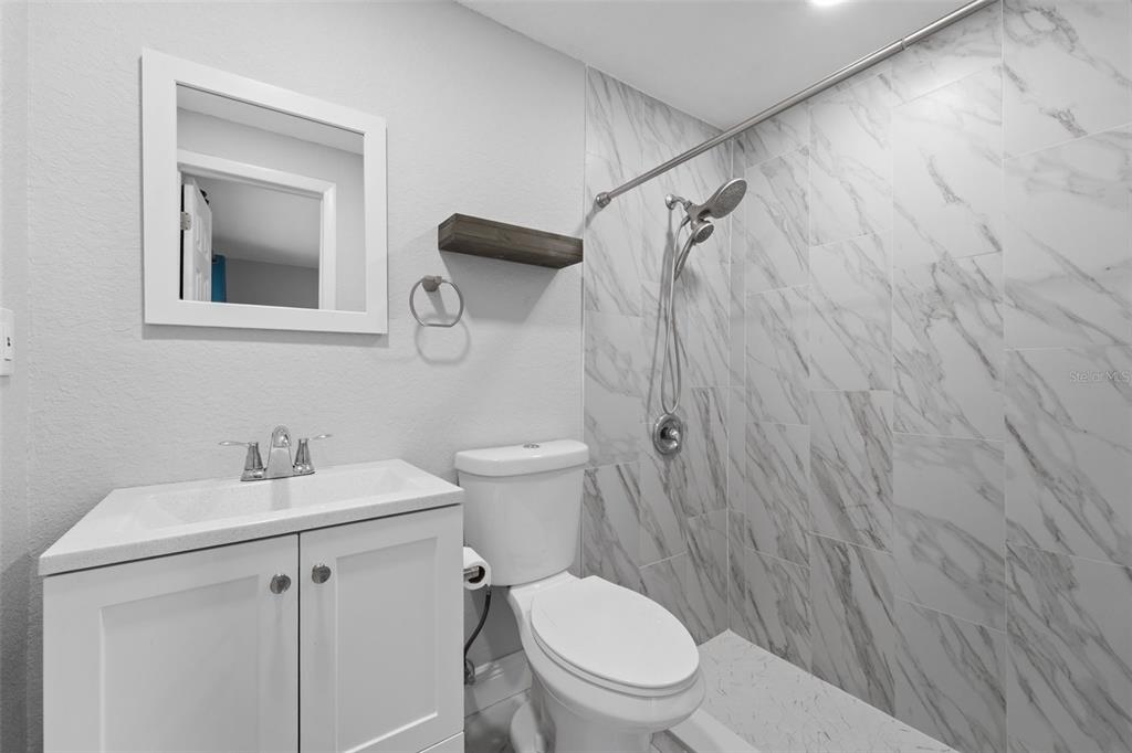4238 Glissade Drive New Port Richey, FL 34652 - Photo 62 of 62 a white toilet sitting next to a bathroom sink