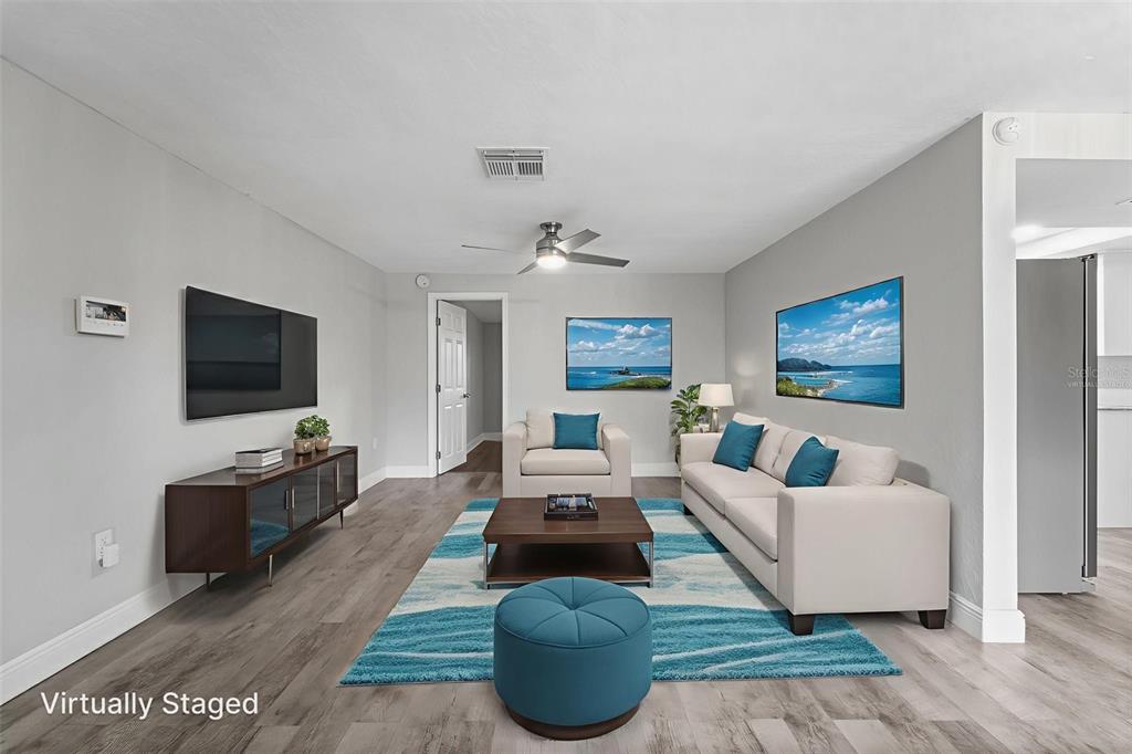 4238 Glissade Drive New Port Richey, FL 34652 - Photo 8 of 62 a living room with furniture and a flat screen tv