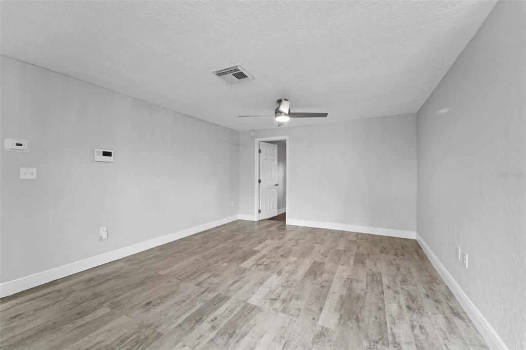 4238 Glissade Drive New Port Richey, FL 34652 - Photo 9 of 62 wooden floor in an empty room