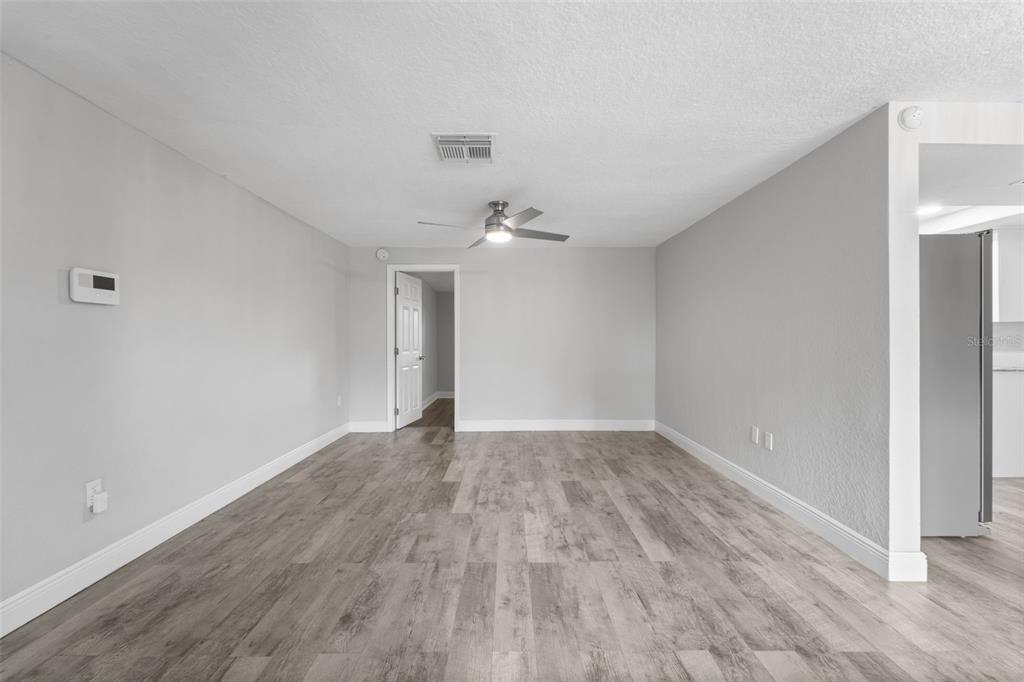 4238 Glissade Drive New Port Richey, FL 34652 - Photo 10 of 62 a view of an empty room with wooden floor